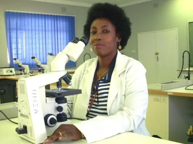 Postgraduate student examining malaria slide